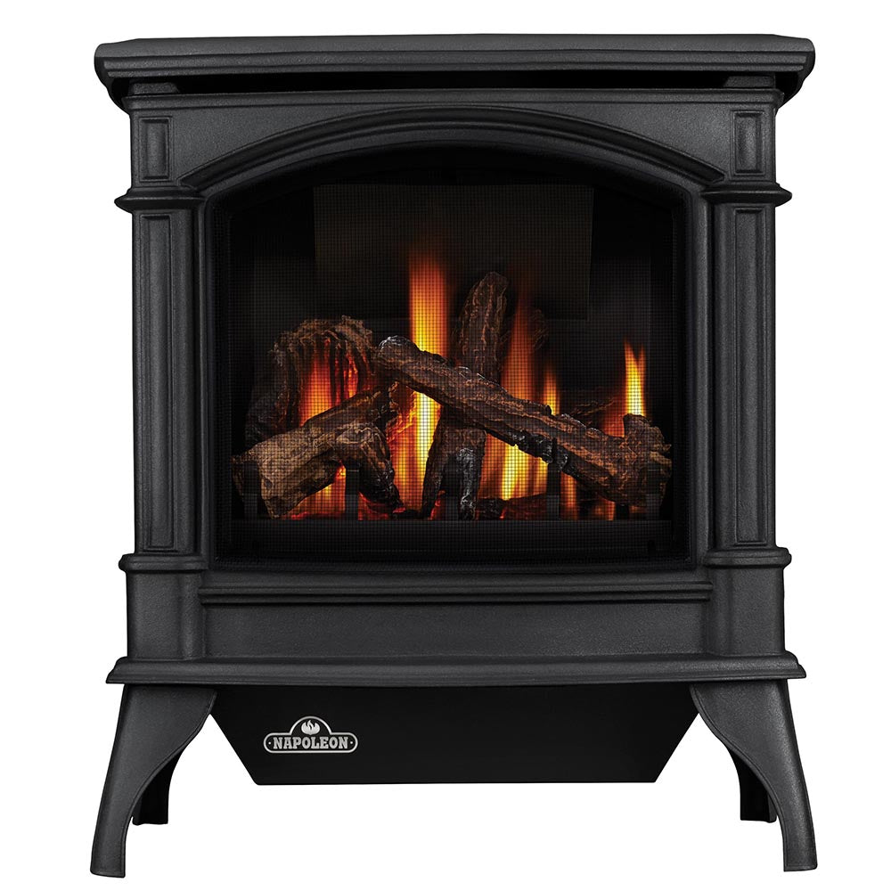 Black cast iron gas stove with arched glass front and visible flame logs