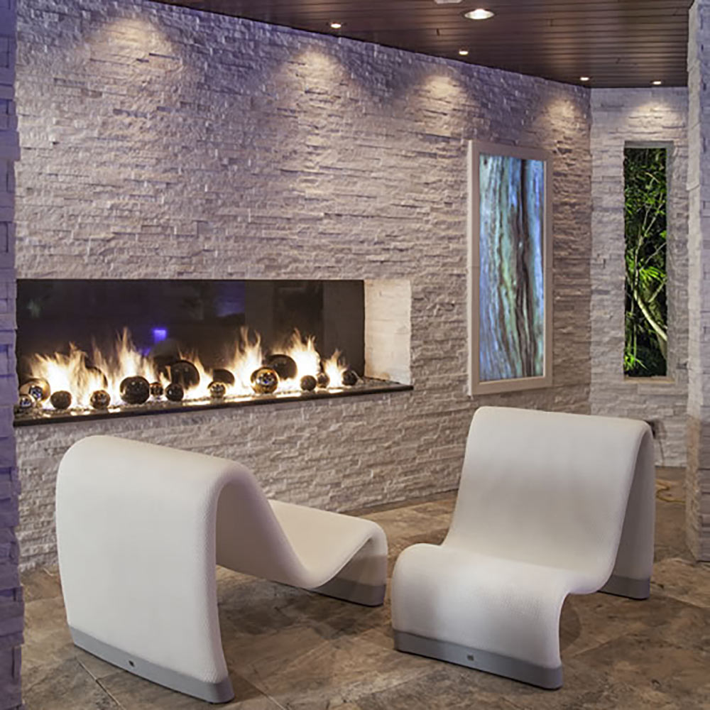 Indoor/outdoor gas fire pit flame in a rectangular wall-mounted burner