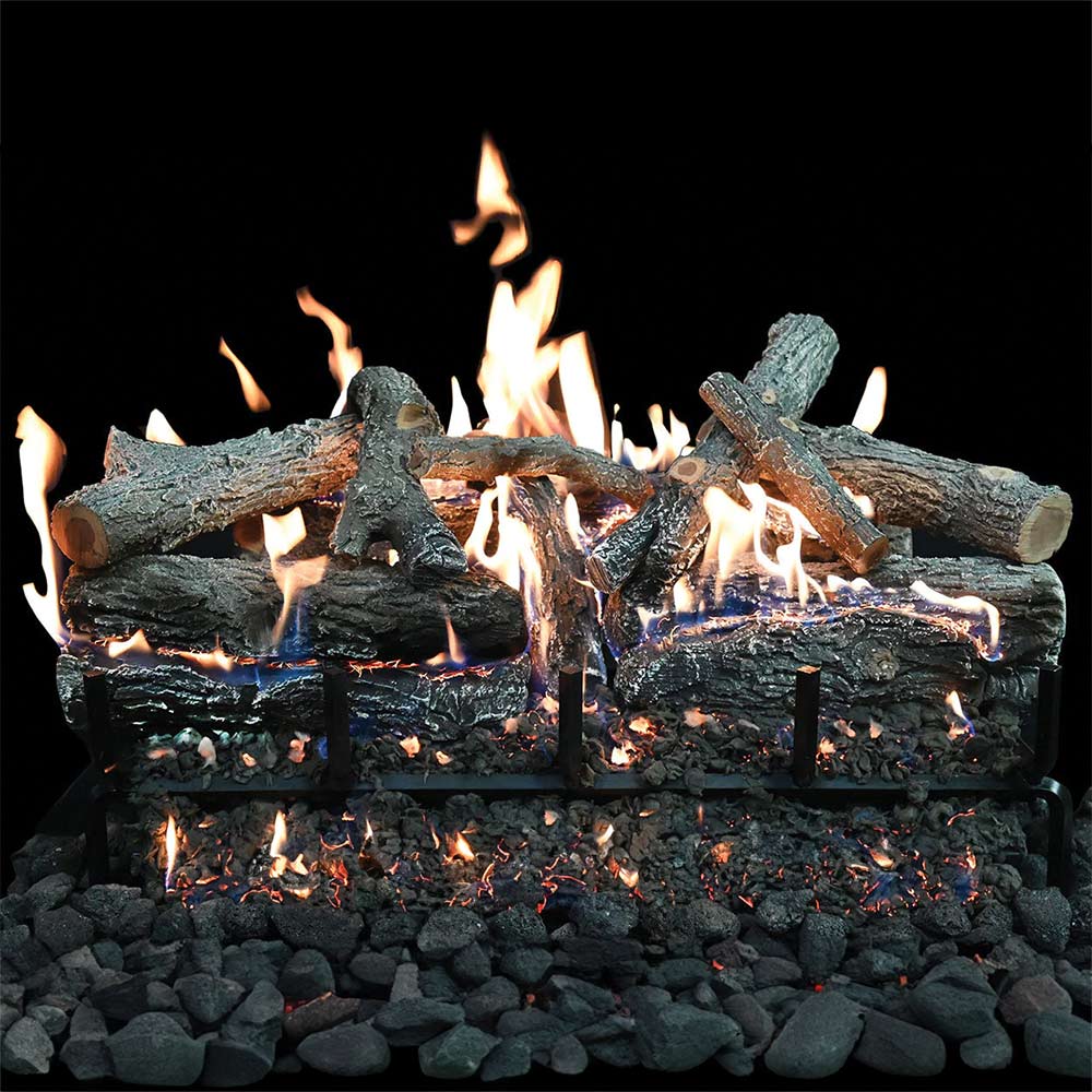 Charred wood gas log set with active flames on dark logs over black lava rock