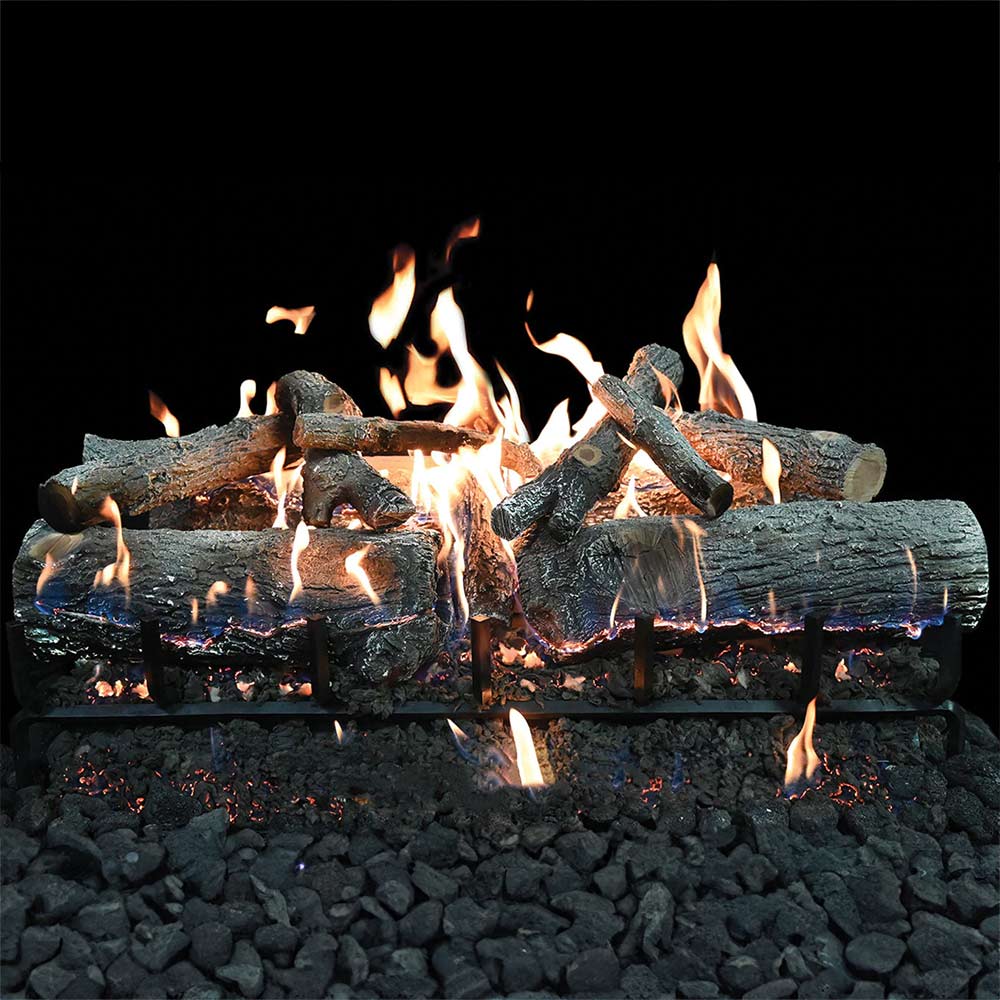 Charred gas log set burning on black base with flames rising above log grate