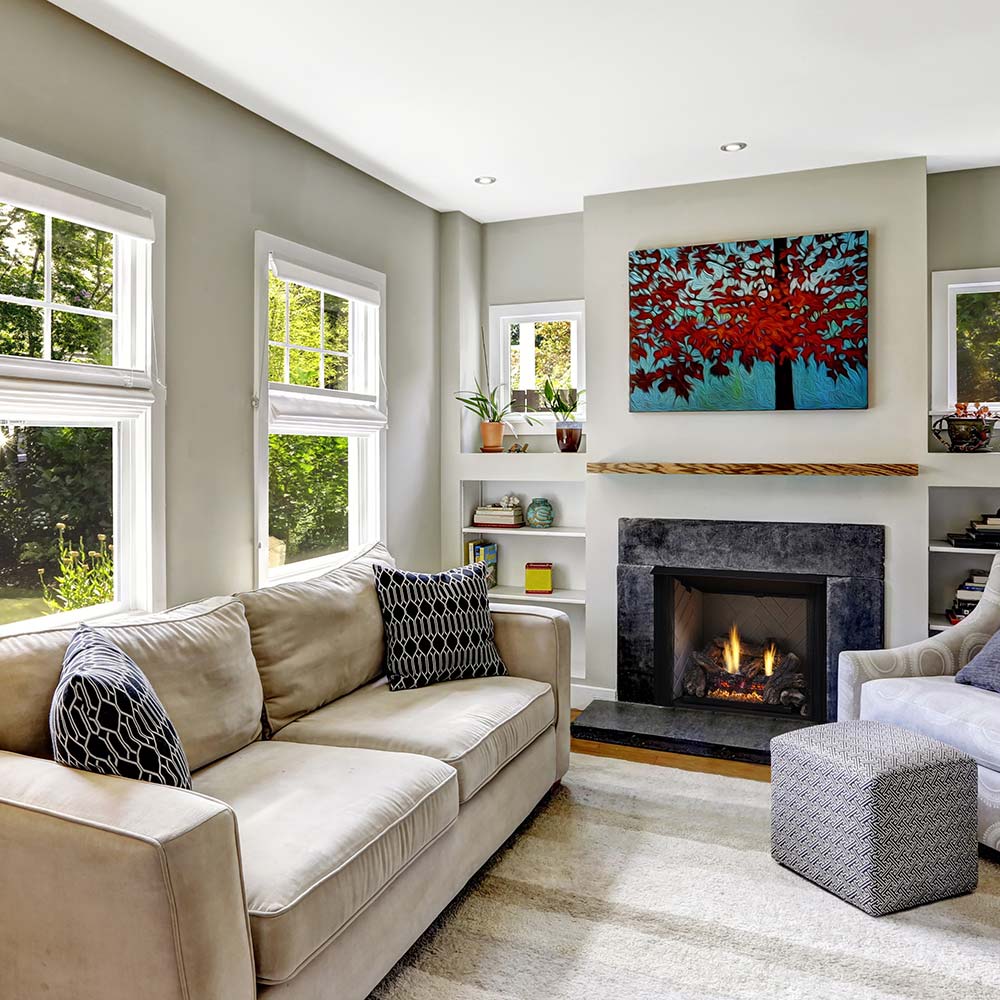 Vent-free gas log set in an indoor fireplace, flames visible behind the screen