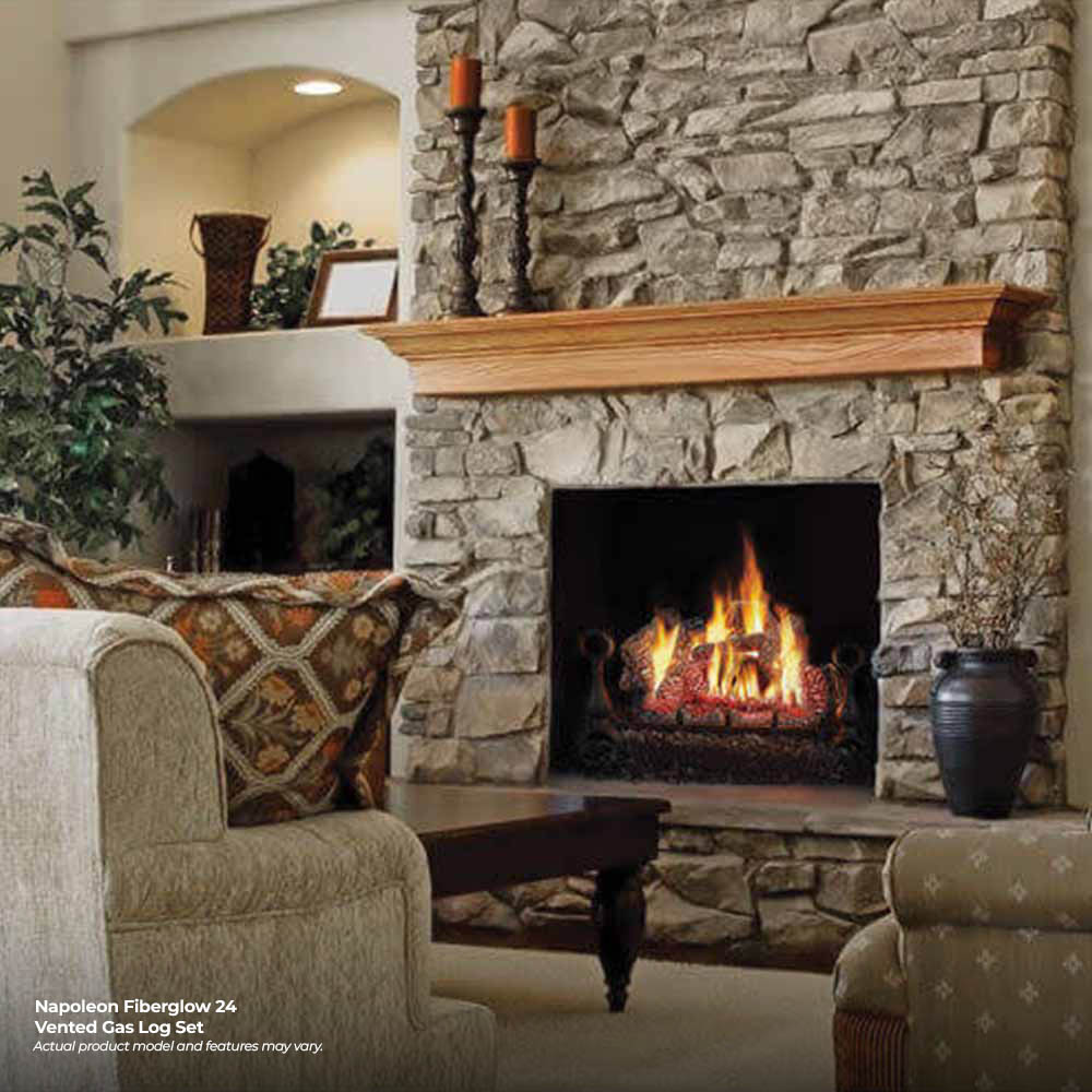 Vented gas log set burning in a fireplace firebox with faux logs and embers.
