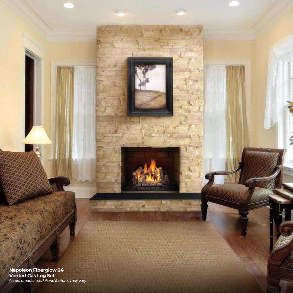 Vented gas log set burning in a masonry fireplace with faux logs and embers.