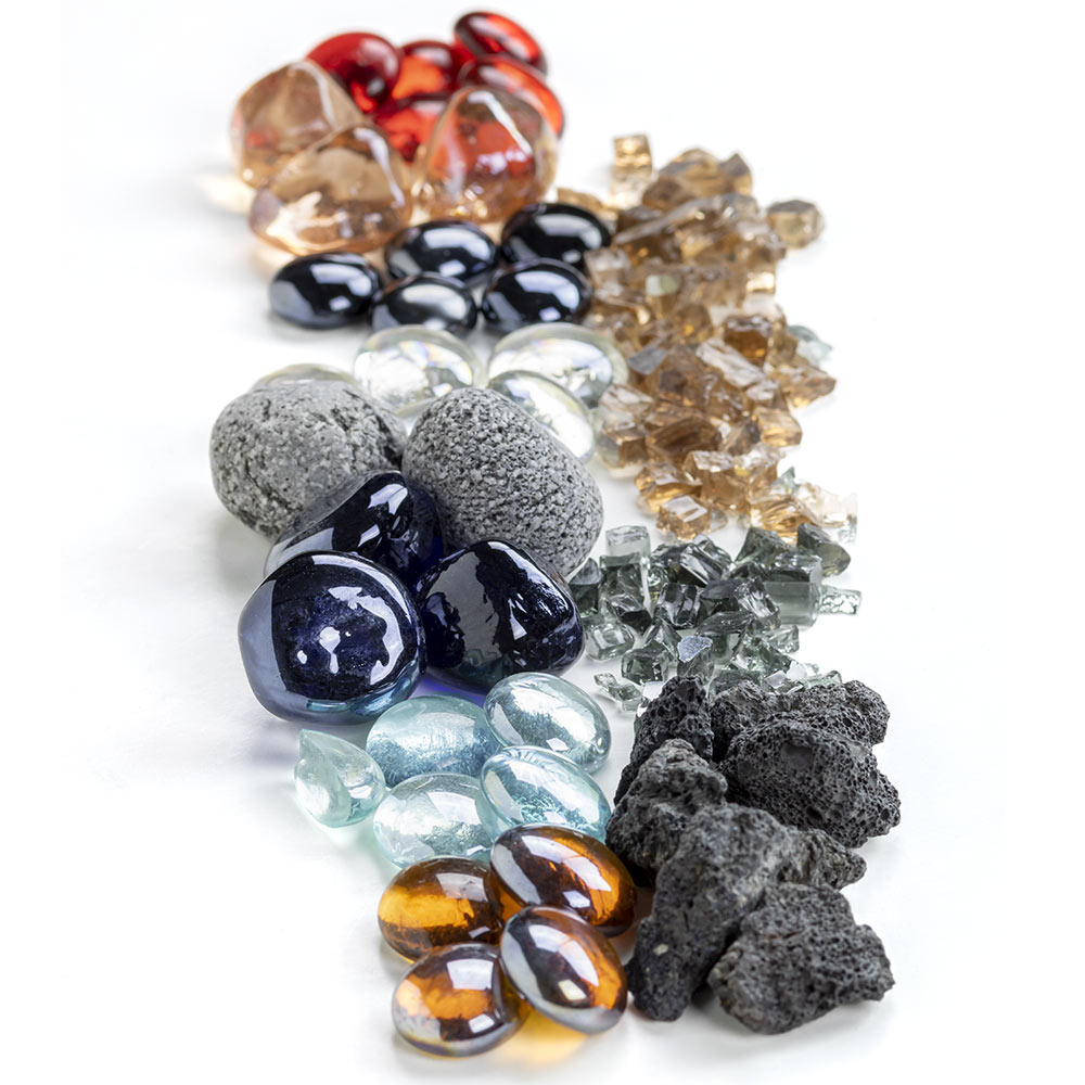 Mixed fire glass and lava rock pile with dark lava, clear and blue glass, and red pieces