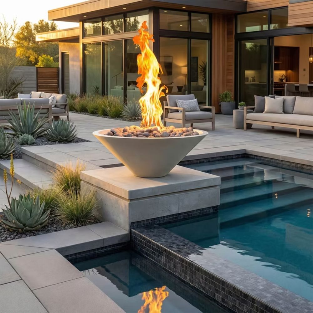 Outdoor concrete gas fire bowl with flame, lava rocks, and rectangular fire base