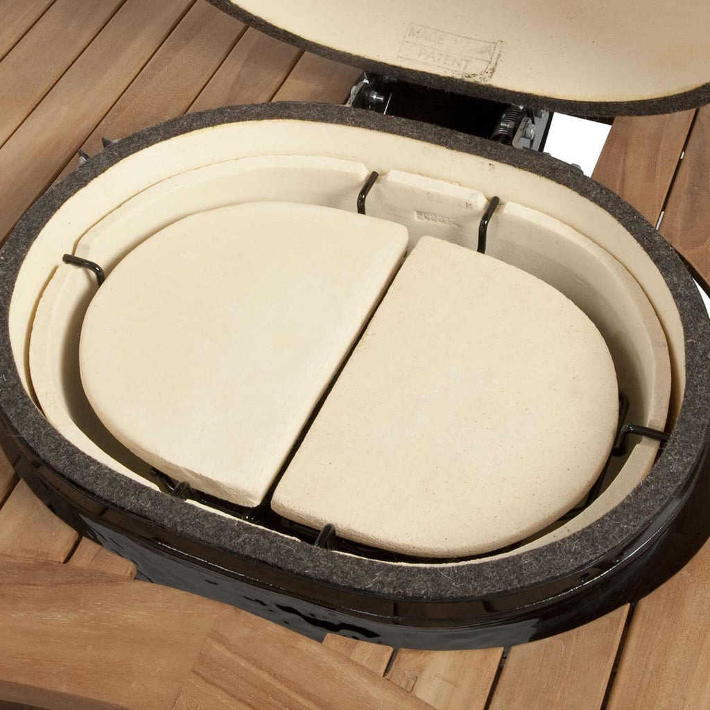 Ceramic heat deflector plates on metal rack inside a round kamado cooker