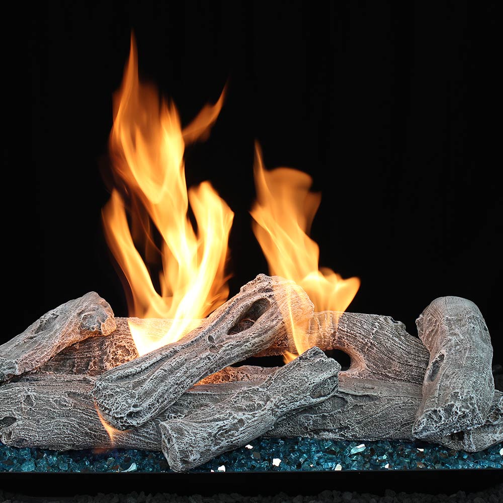 Vented gas log set with driftwood-style logs, burning flames