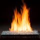 Vented gas fire glass set with burner, showing glowing flames over dark fire glass