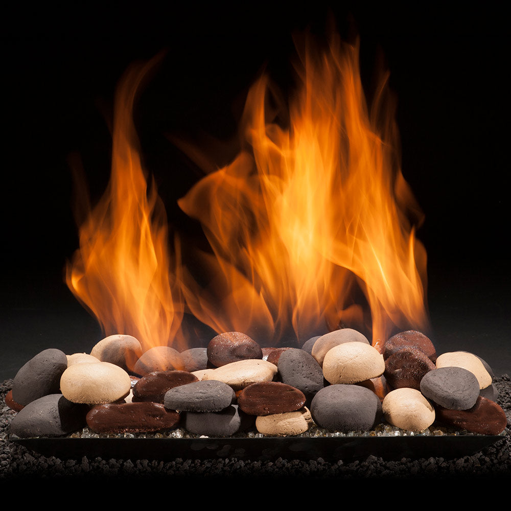Gas fireplace pan burner with blazing flames over river stones