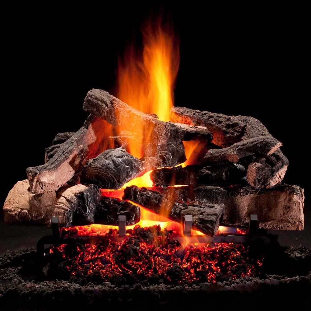 Gas log set with glowing embers and orange flames over dark, charred logs