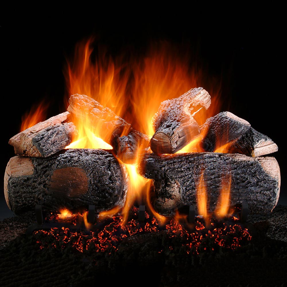 Vented gas log set with charred log pieces and orange flames