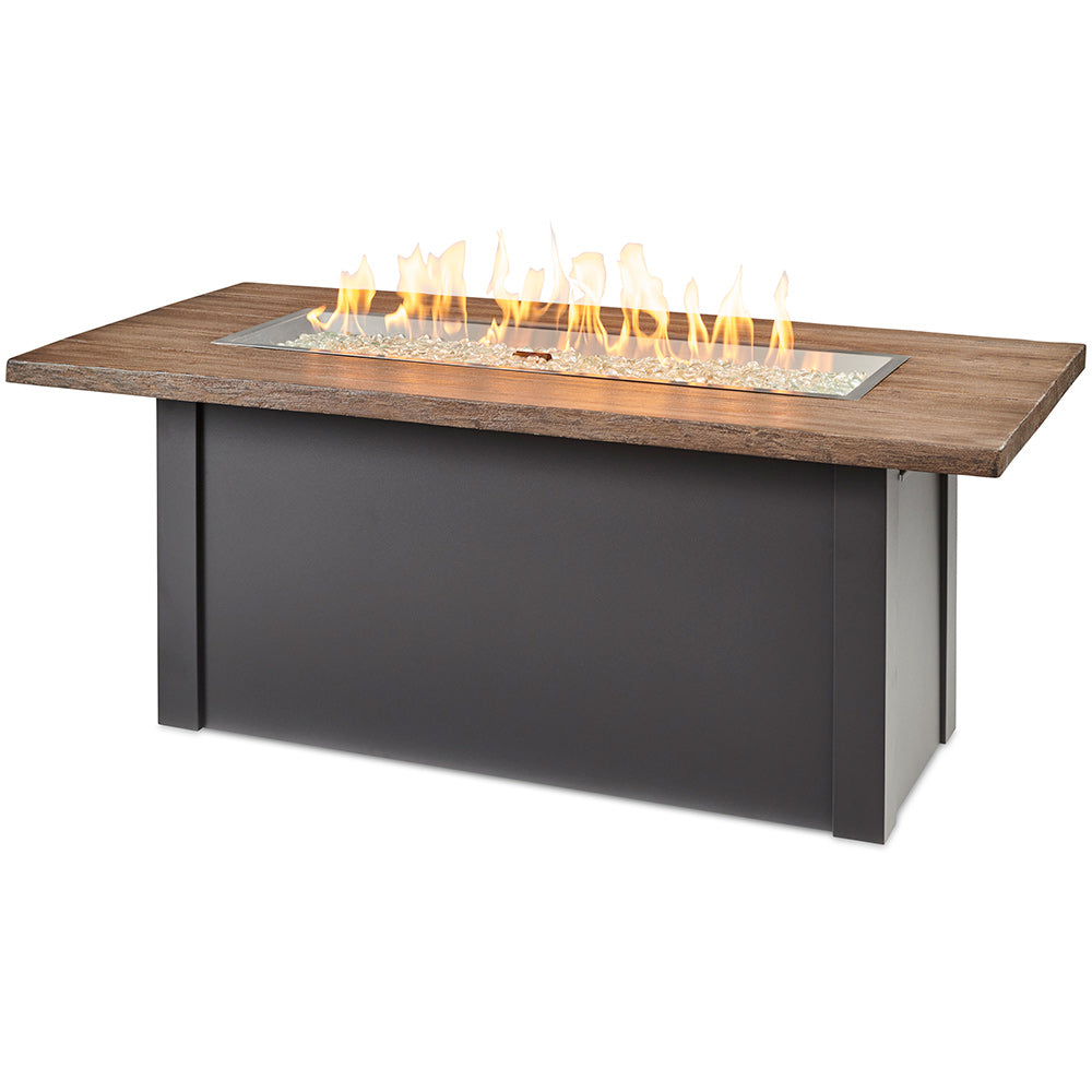 Linear gas fire table with driftwood-look top and black base, glass burner with flames