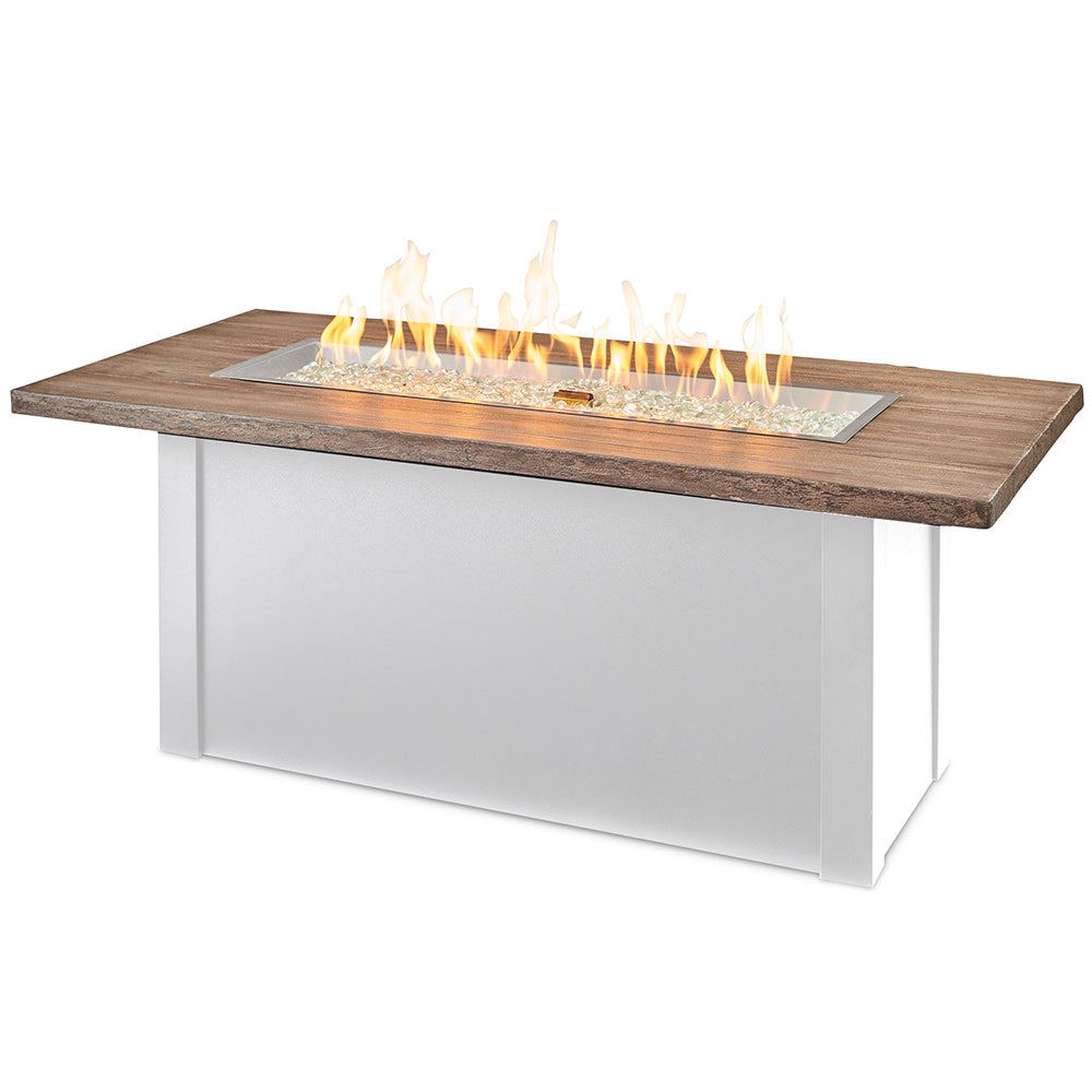 Linear gas fire table with driftwood-look top and white base, glass burner with flames