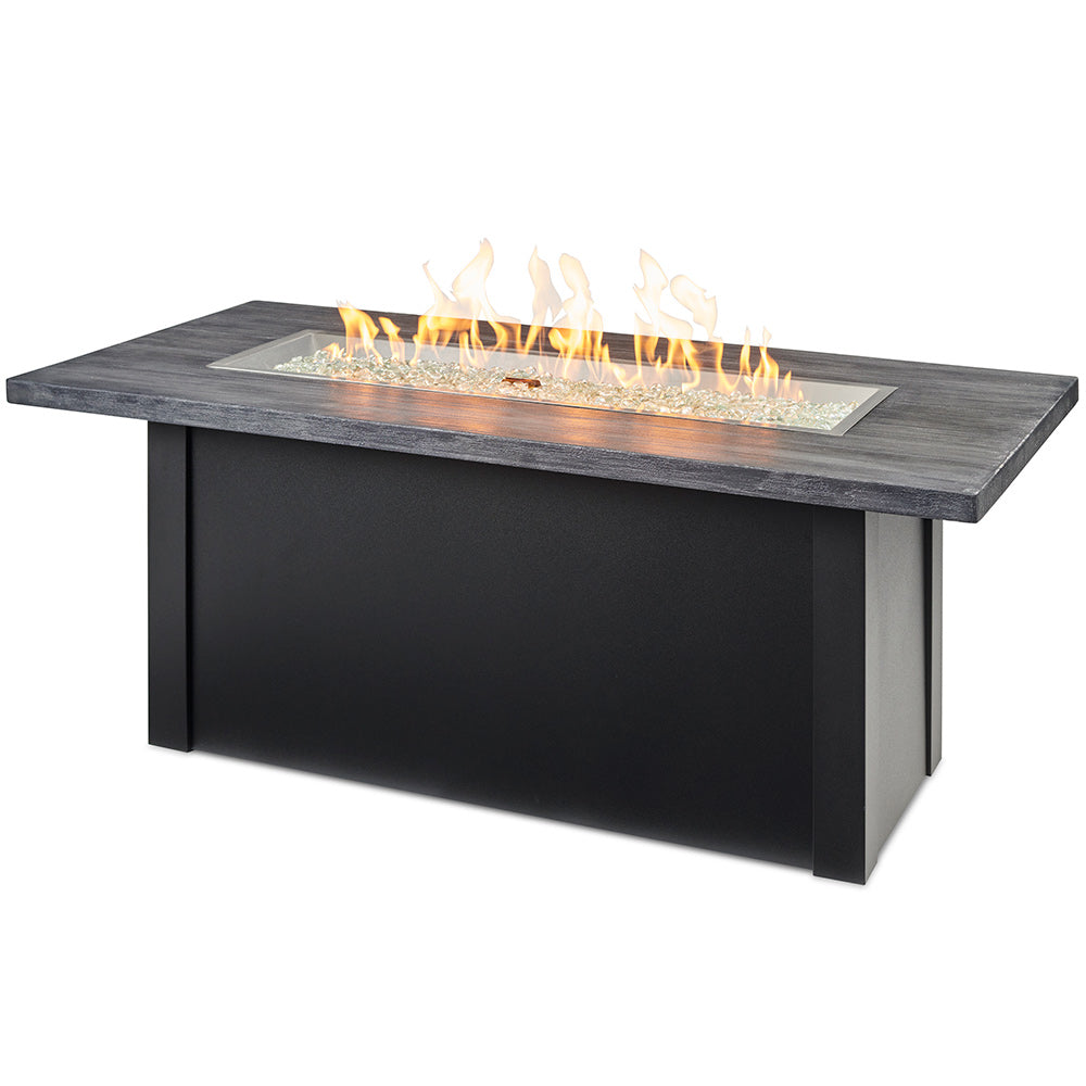 Linear gas fire table with gray top and dark base, burning flames in central tray