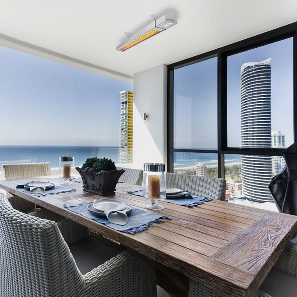 Wall-mounted patio heater with glowing heating elements under ceiling