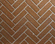Herringbone brick fireplace liner with brown tiles and white chevron mortar