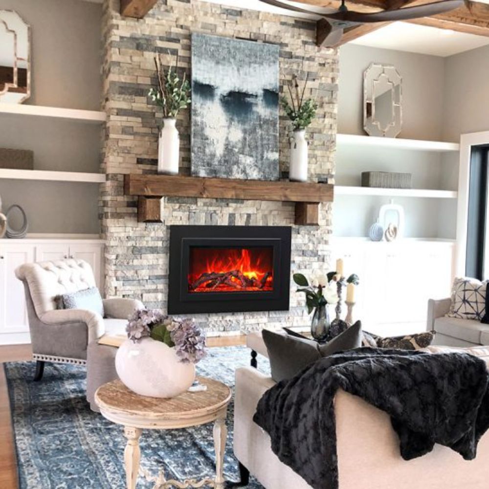 Black steel electric fireplace insert installed in a stone mantel surround, with visible flame glow.