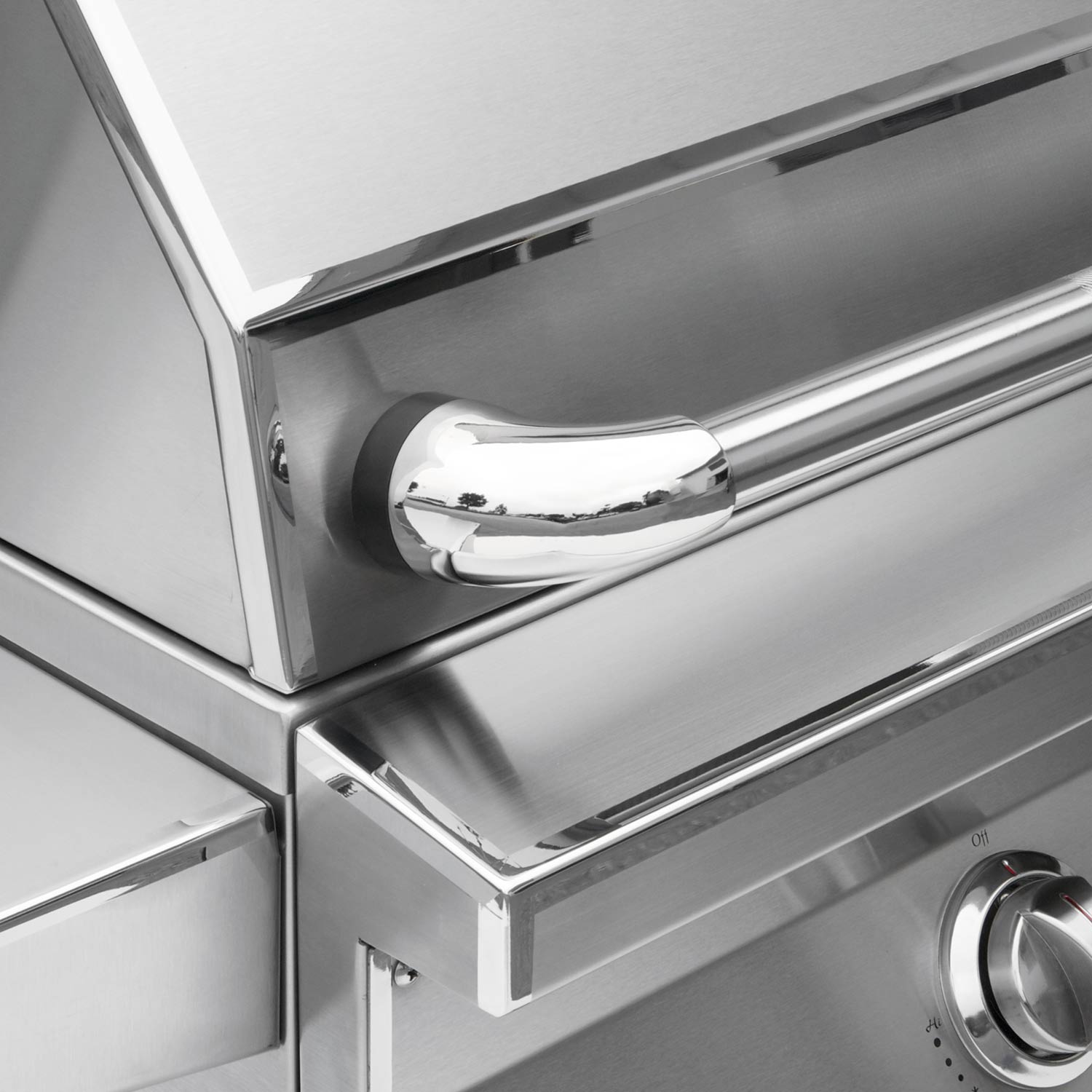 Stainless grill control panel with large knob and front handle area.