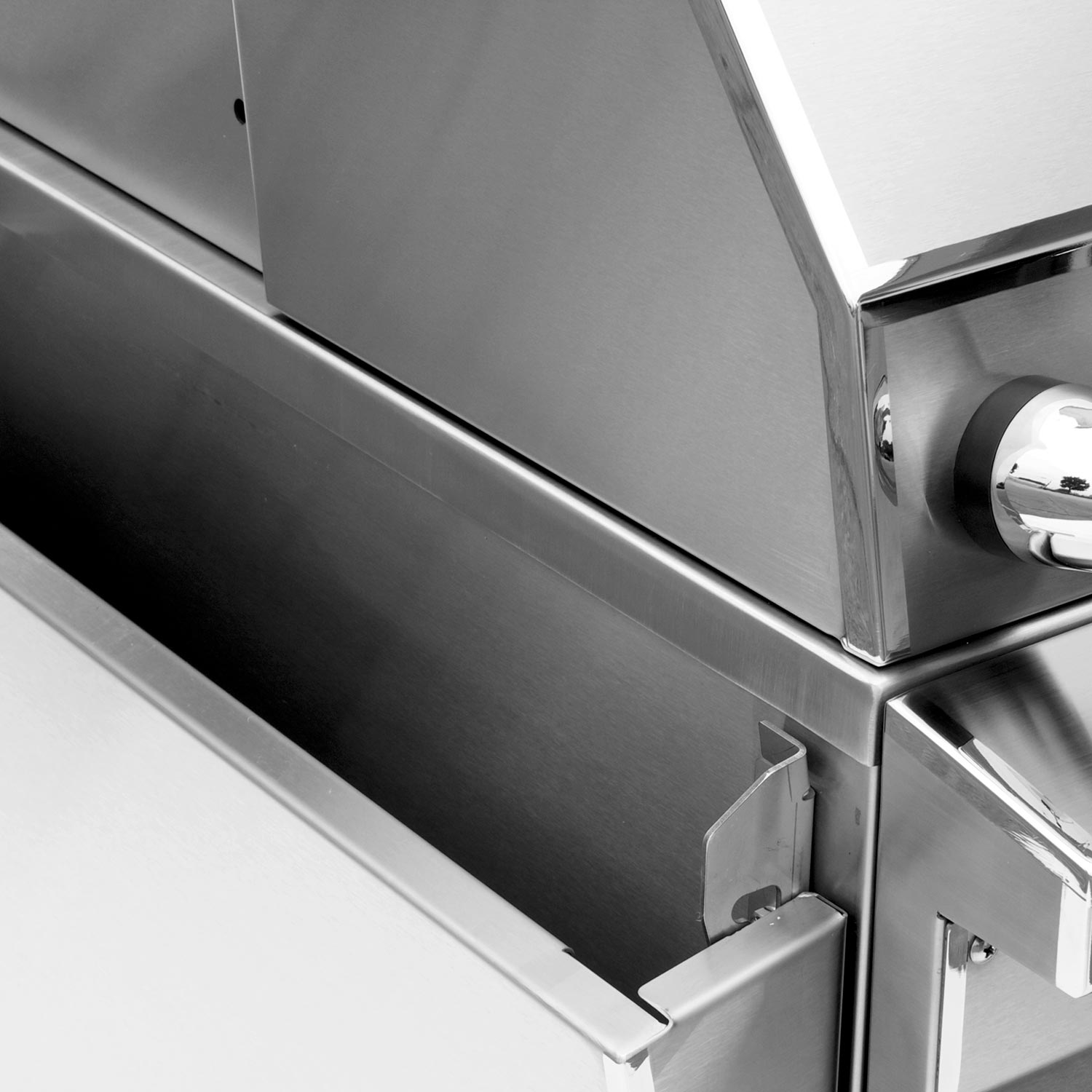 Stainless grill front panel with vented strip and storage door handle