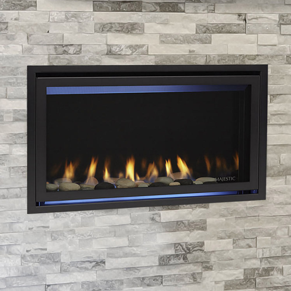 Direct vent gas fireplace with black surround, glass panel, and glowing blue flames