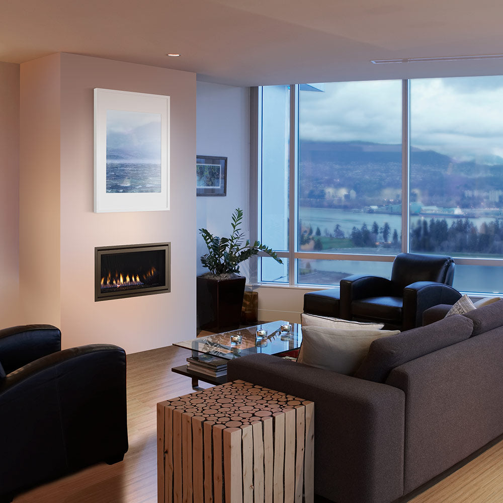 Direct vent gas fireplace with black frame installed in a living room wall