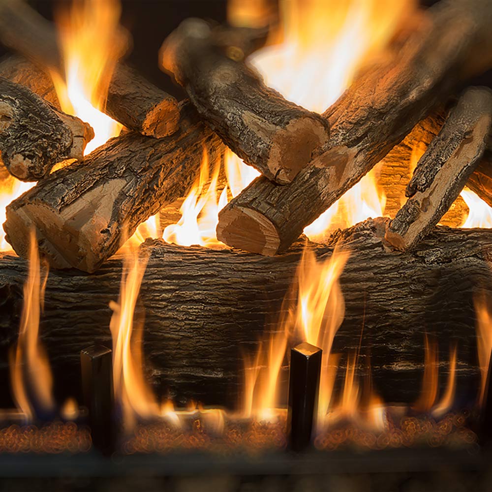 Weathered oak gas logs with bright flames and glowing ember bed