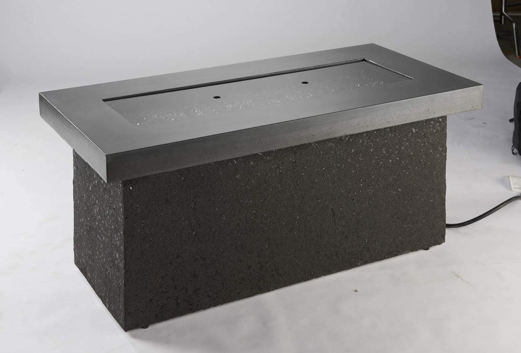 Rectangular gray burner cover with metal lid frame and dark glass opening
