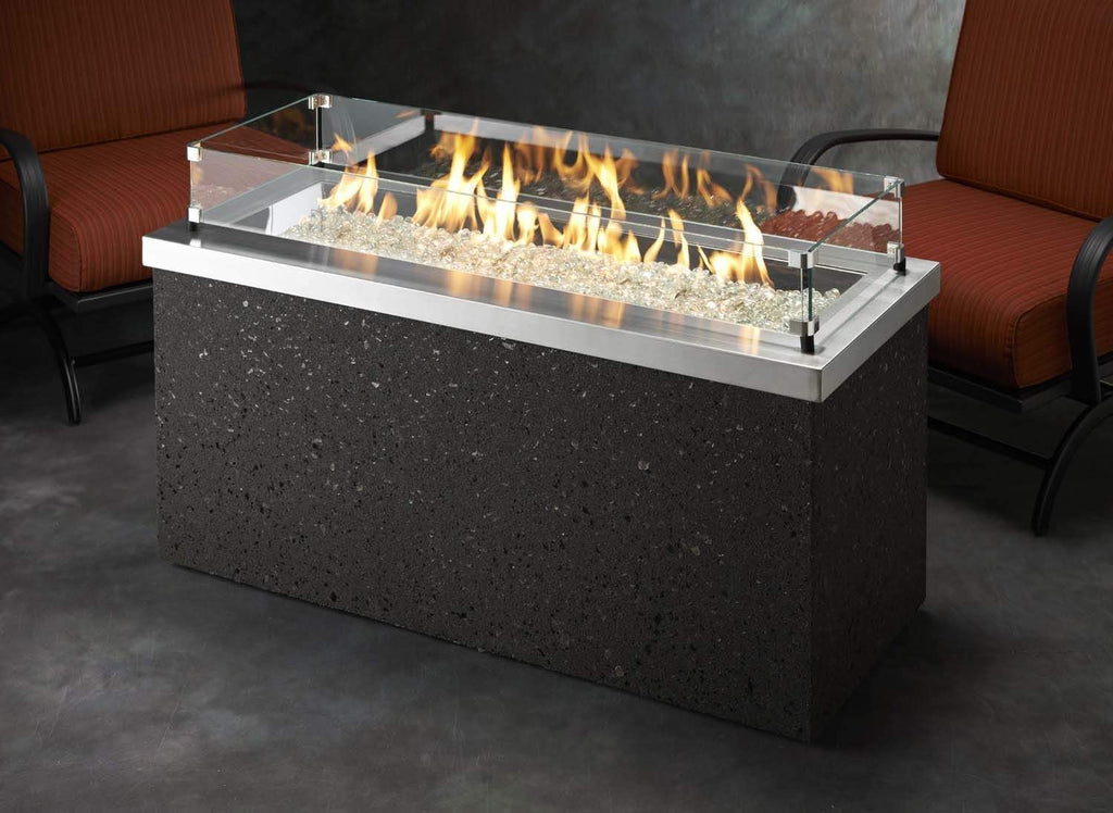 Rectangular glass wind guard with clear panels around a fire pit burner