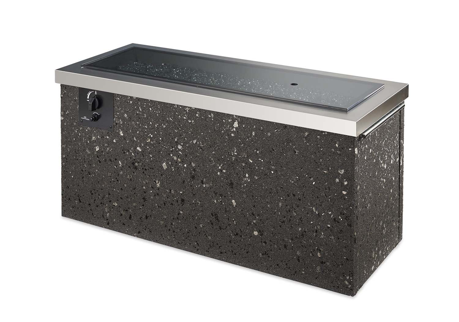 Outdoor gas fire pit with black speckled stone body and stainless steel rim, no flames