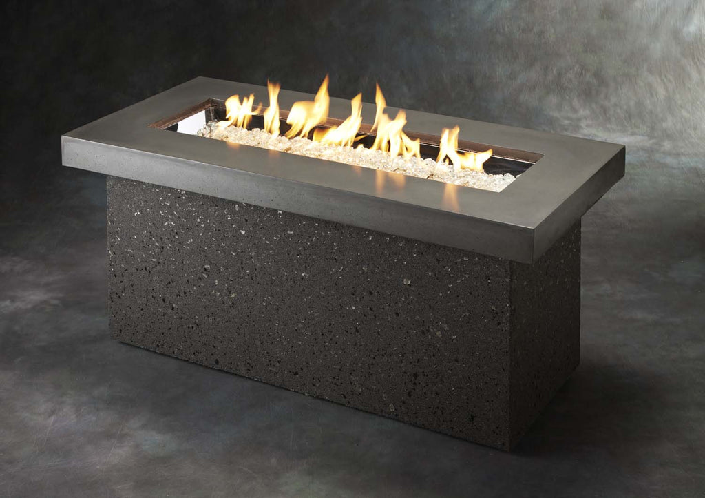 Outdoor gas fire pit with open flames and dark speckled base, rectangular black rim