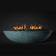 Seafoam oval fire pit with flames and lava rocks