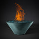 Round fire pit bowl with blue fire glass and orange flames, teal green finish