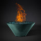 Round fire pit bowl with orange flames, green-teal finish, blue glass burner