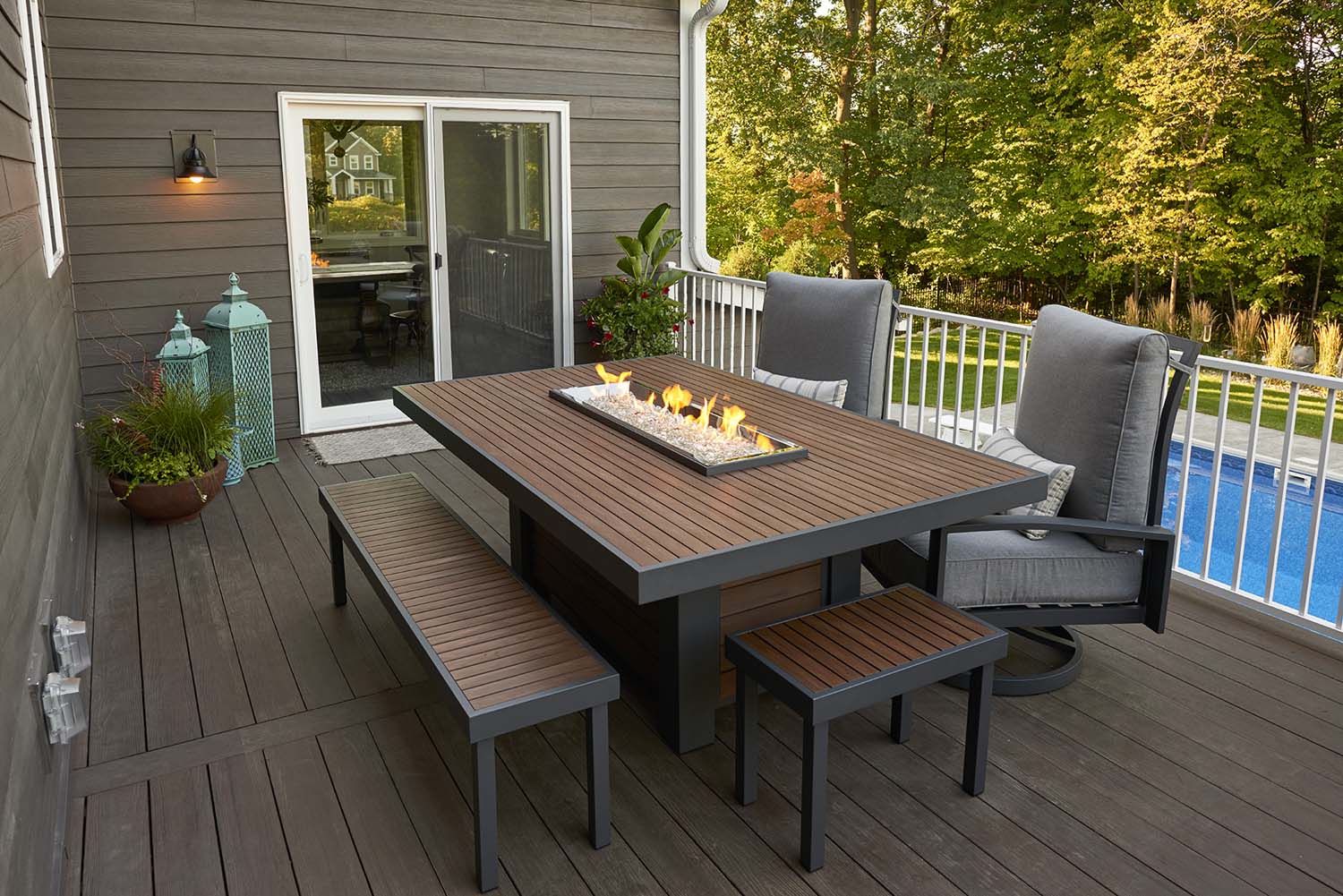 Outdoor patio bench with wood slat seat and dark frame in outdoor dining set