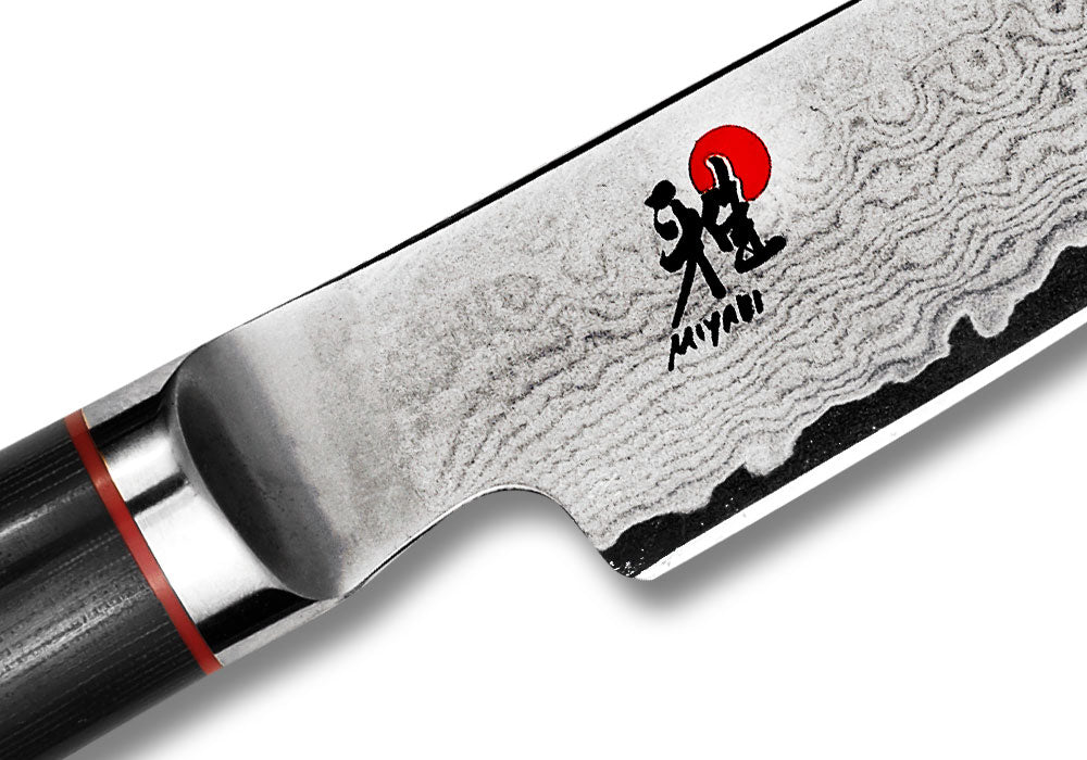 Paring knife blade with wavy Damascus finish and red-and-black logo
