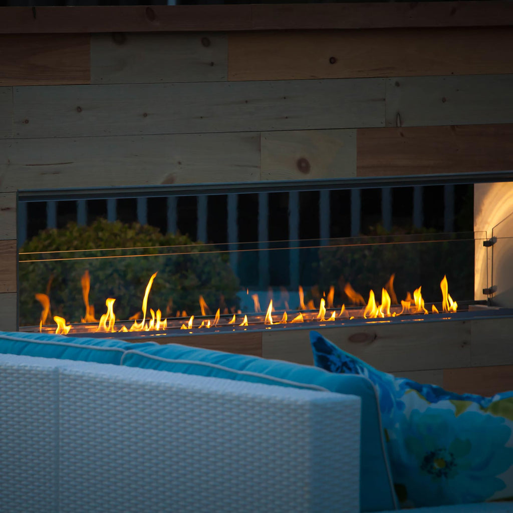 Outdoor fireplace burner and metal firebox opening with visible flames