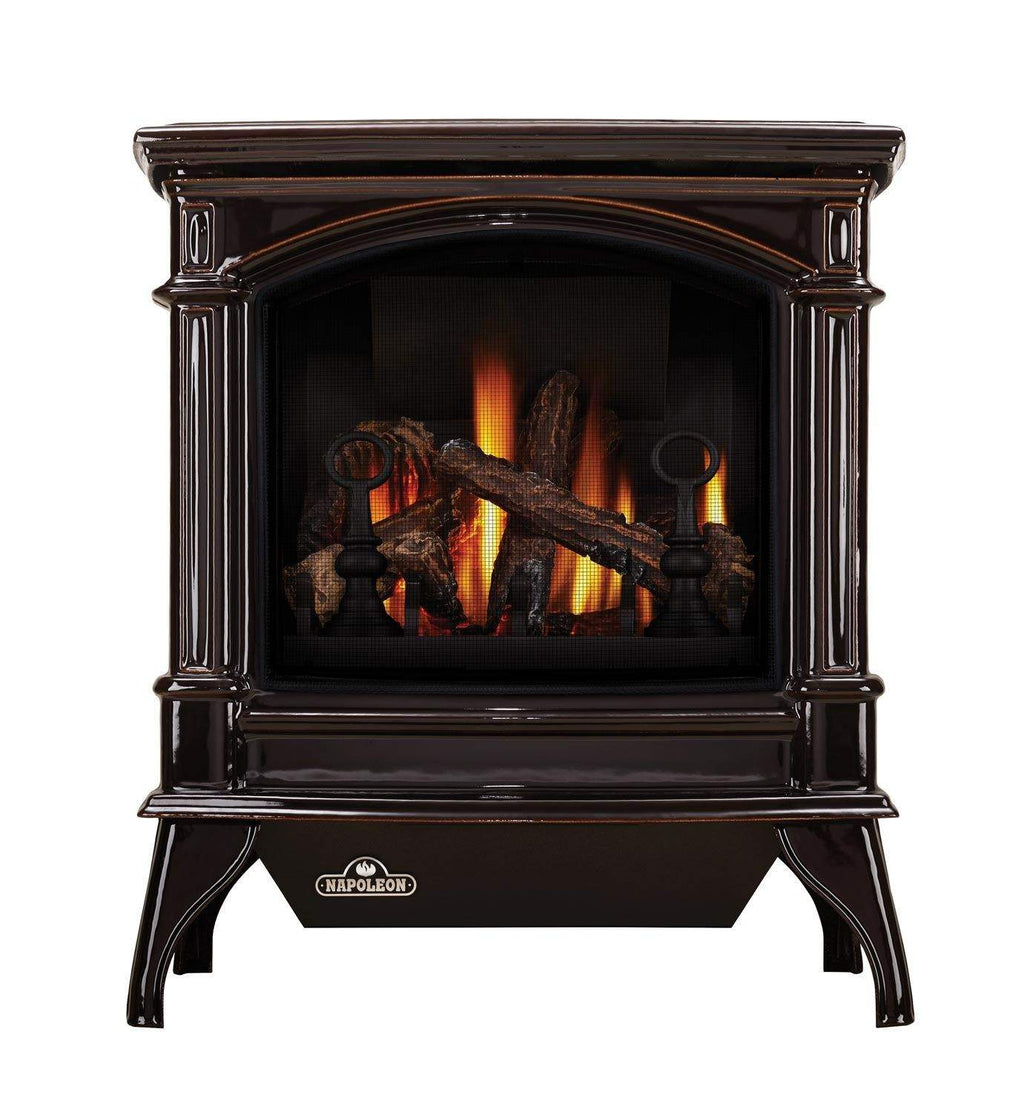 Dark brown cast iron gas stove with arched glass front and flame logs