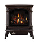 Dark brown cast iron gas stove with arched glass front and flame logs
