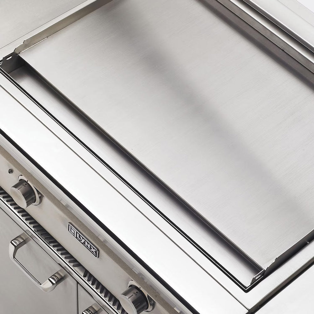 Stainless built-in gas grill cooking surface with control knobs at left and right
