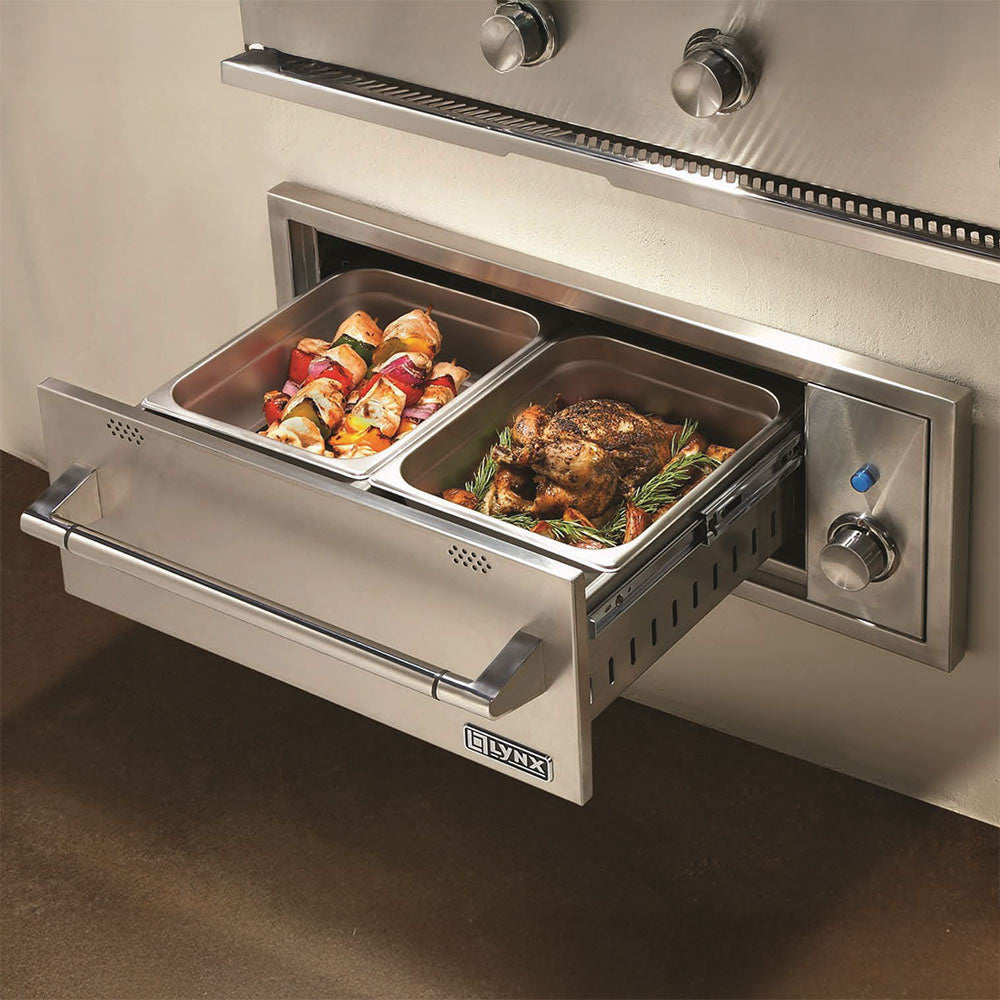 Open built-in warming drawer with two food compartments and stainless side handles