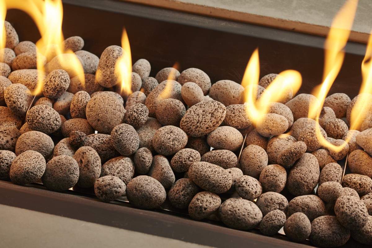 Tumbled lava rock tray filled with dark gray, porous textured stones