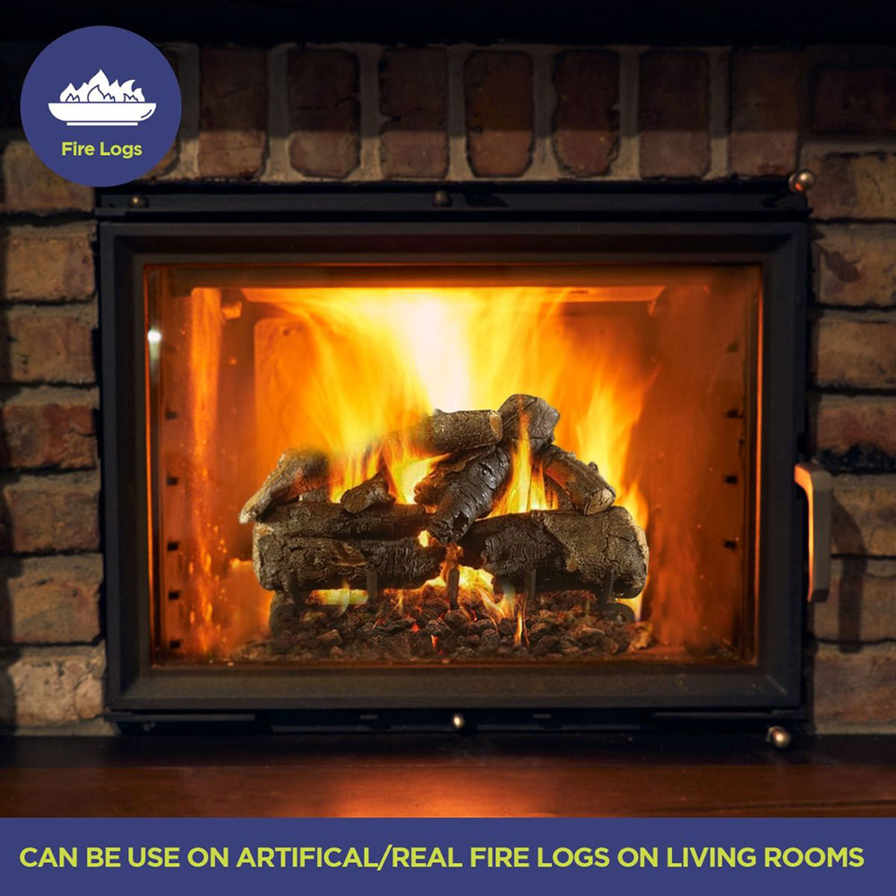 Fireplace firebox with black lava rocks beneath burning logs