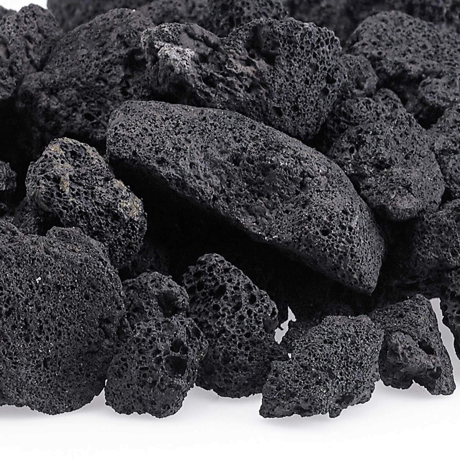 Dark black lava rock pieces with porous, pitted texture close-up.