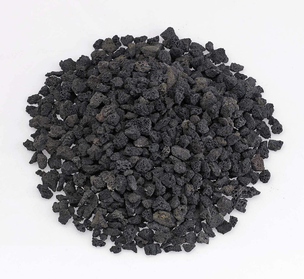 Small black lava rock, rough porous stones in a pile