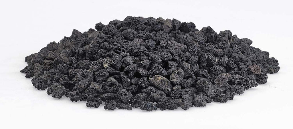 Small black lava rock stones spread out, rough porous texture