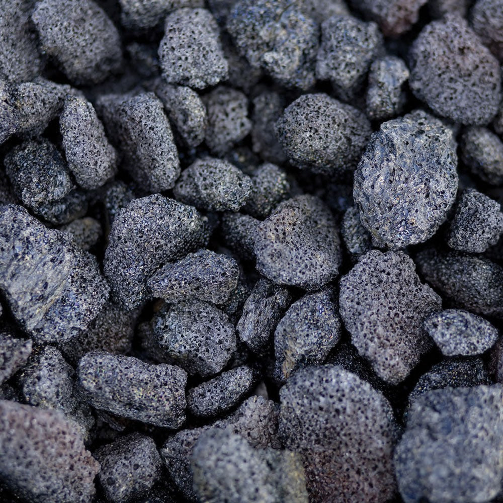 Pile of dark gray lava rock media for a gas fire pit insert