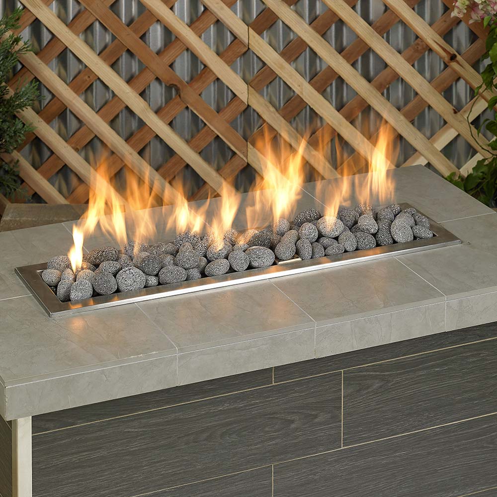 Gray lava stones lining a fire pit, medium 1–2 inch pebbles with flames