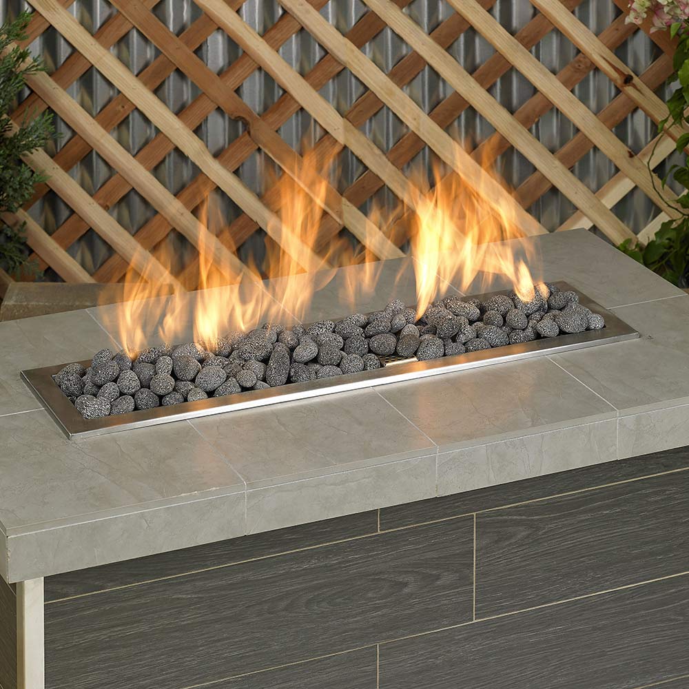 Gray lava stones in a rectangular fire pit basin with flames