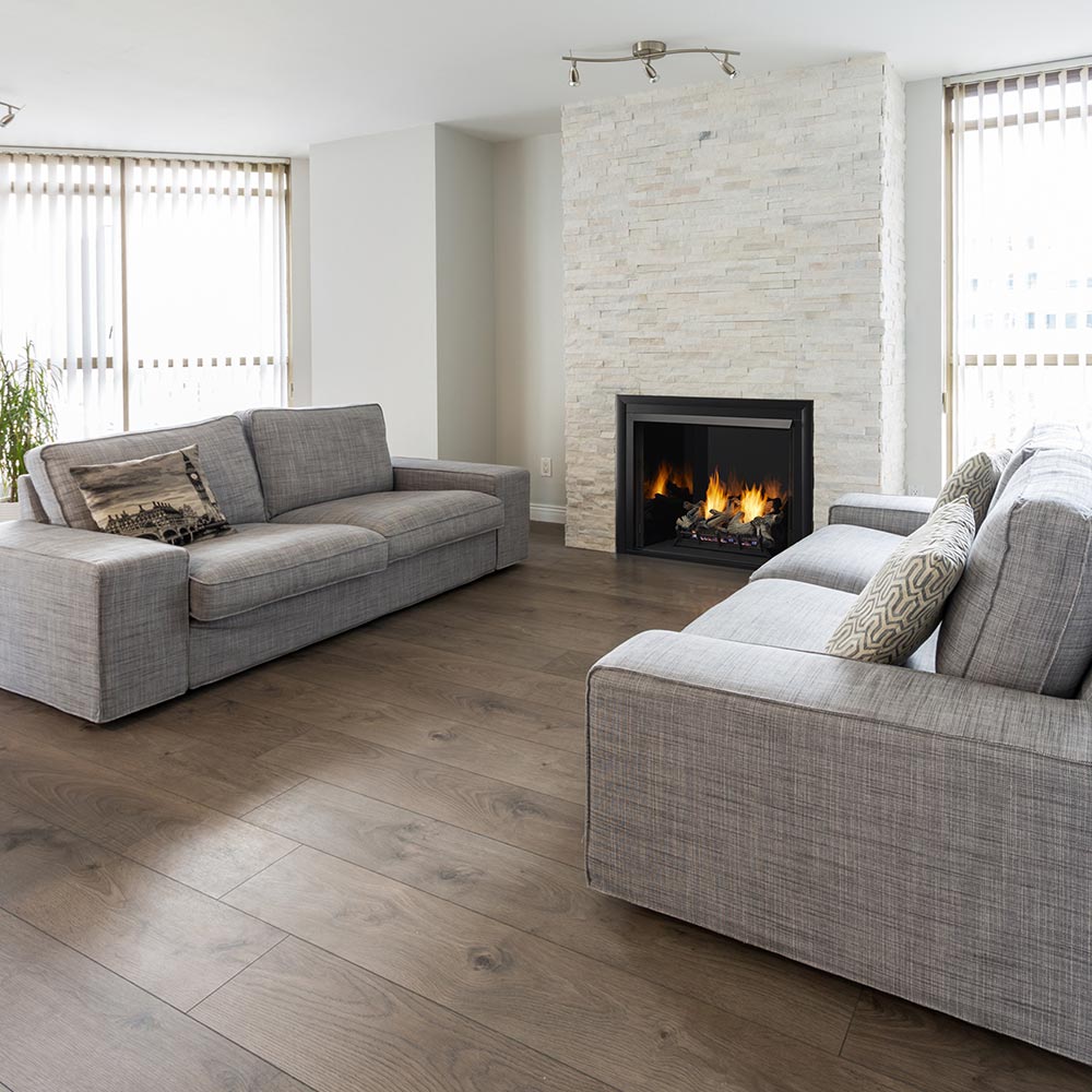 Vent-free gas fireplace insert with black firebox, burning logs inside