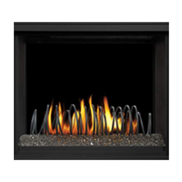 Black metal fire art with curved rings in front of flames inside a fireplace